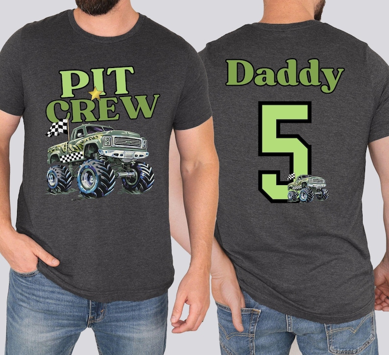 Daddy wearing a dark gray t-shirt with the front of the shirt says "PIT CREW" above a monster truck design. The back of the shirt says "Daddy 5" with a monster truck graphic.