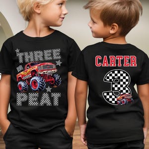 Op de afbeelding: Zwarte t-shirts met een monster truck ontwerp. De voorkant van het shirt zegt "THREE PEAT" met een rode monster truck afbeelding. De achterkant van het shirt zegt "CARTER" en een nummer "3" met een monster truck afbeelding.