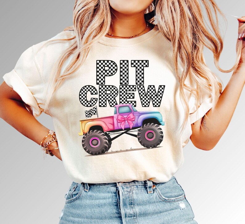 Pink Coquette Bow Sparkle Monster Truck Jam Girls Birthday Pit Crew Party Adult  and Kids Shirt with Rainbow colored truck pastel and black and white checkered letters with racing flag. Model is wearing comfort colors Ivory tee shirt