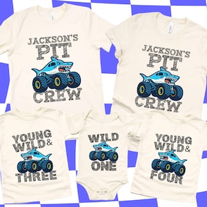 Family Matching Monster Truck T-shirts in Natural Cream Color with Shark Monster Truck Megalodon Cartoon style that have chalk art/sketch style letters that say " Jackson's Pit Crew" Young Wild & Three, Wild One, Young Wild and Four. Perfect for Birthday Gift and Pit Party Race Day T-shirts. Personalized Family Monster Truck Jam Tees.