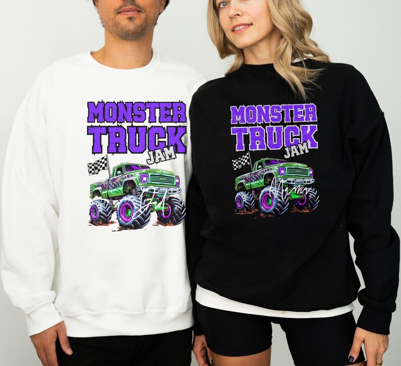 May include: Two sweatshirts with a monster truck graphic and the text "Monster Truck Jam" in purple. The sweatshirt on the left is white and the sweatshirt on the right is black.