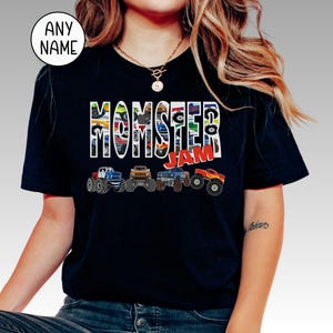 May include: A black t-shirt with a graphic of monster trucks and the text "Monster Jam".