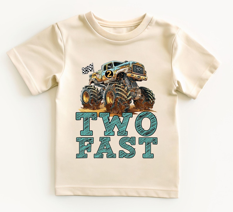 Pictuered is a natural colored t-shirt which says TWO FAST in blue sketch big graphic letters underneath a big monster truck with a checkered flag waving in the breeze behind. there is a custom age number on the side of the truck.