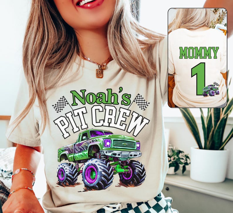 May include: A beige t-shirt with the text "Noah's PIT CREW" and a green monster truck graphic. The truck has purple and green accents. The back of the shirt has the word "MOMMY", the number "1", and a monster truck graphic.