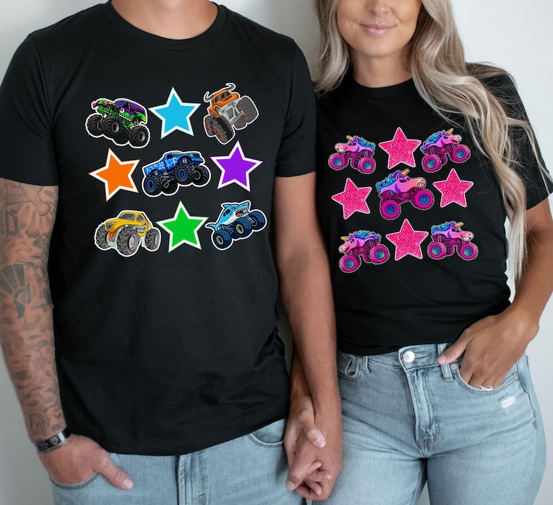 May include: Black t-shirts with colorful monster truck and star graphics. One shirt features various monster trucks, while the other showcases unicorn monster trucks. The designs include green, blue, orange, purple, and yellow trucks.