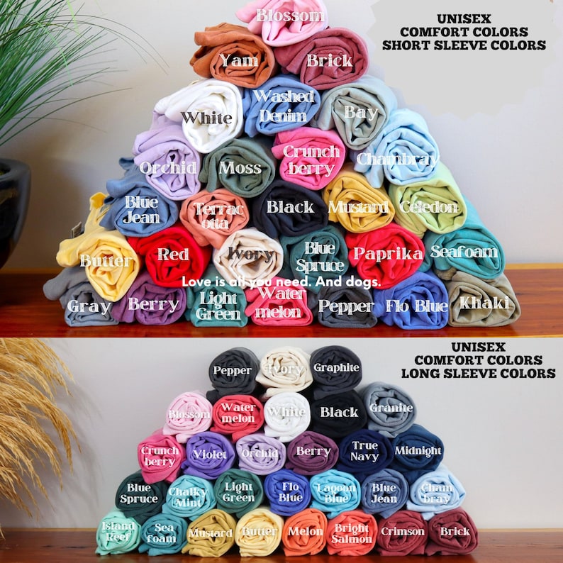 May include: A collection of rolled up t-shirts in various colors, including white, red, blue, green, yellow, and black. The t-shirts are arranged in a pyramid shape. The text "UNISEX COMFORT COLORS SHORT SLEEVE COLORS" and "UNISEX COMFORT COLORS LONG SLEEVE COLORS" is displayed at the top of the image.