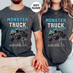 May include: Two grey t-shirts with a blue monster truck graphic and the text "Monster Truck Jam". One shirt says "Dad" and the other says "Mama".