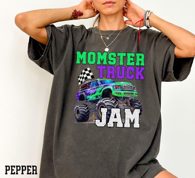 Model is wearing a comfy soft comfort colors T-Shirt Tee Green Purple Monster truck big Tires Black white Checkered flag family Matching Jam Birthday Boy dude Dadster Kidster