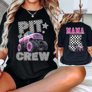 Pode incluir: Camiseta preta com um gr&aacute;fico de um monster truck rosa e as palavras "PIT CREW" em letras quadriculadas. A parte de tr&aacute;s da camiseta tem a palavra "MAMA" acima do n&uacute;mero "5" com um design quadriculado e um pequeno monster truck.
