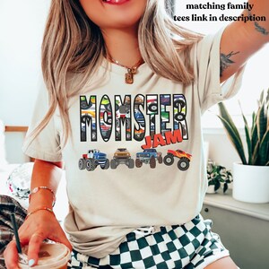 May include: A white t-shirt with the words "Monster Jam" printed on it. The words are made up of images of monster trucks.