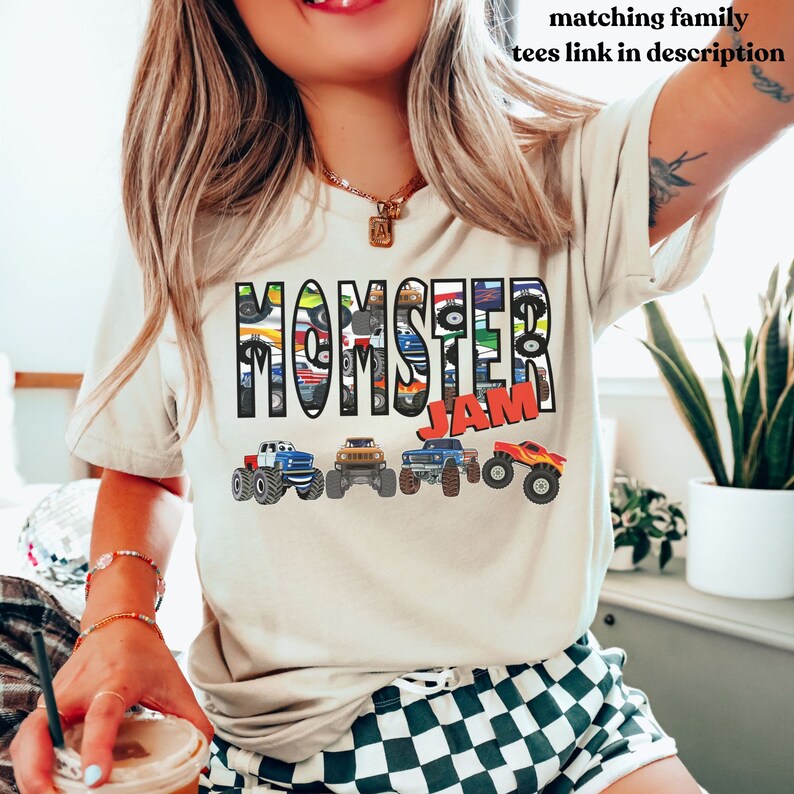May include: A white t-shirt with the words "Monster Jam" printed on it. The words are made up of images of monster trucks.