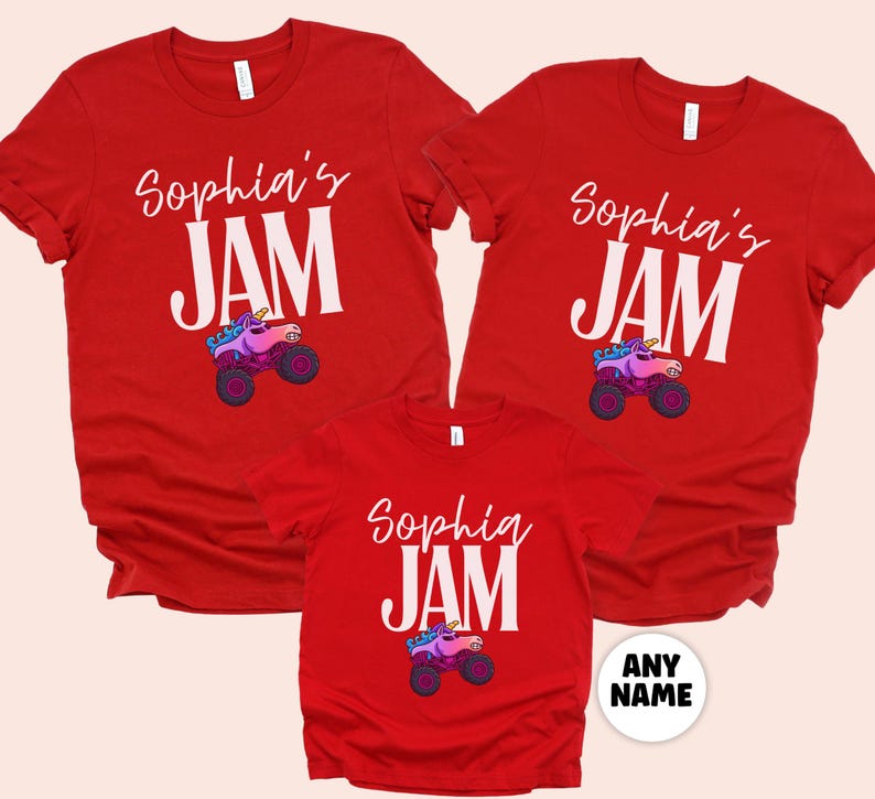 May include: Red t-shirts with the text "Sophia's JAM" in white, featuring a cartoon unicorn monster truck. The shirts are short-sleeved and suitable for a family or group. The design includes a colorful unicorn and truck.