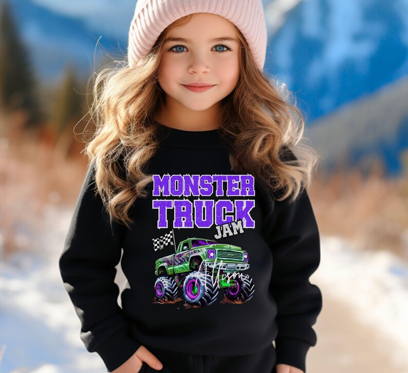 May include: A black sweatshirt with a purple "Monster Truck Jam" graphic and a green monster truck with purple accents.