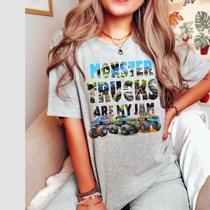 May include: Gray t-shirt with a graphic of monster trucks and the text "Monster Trucks Are My Jam".