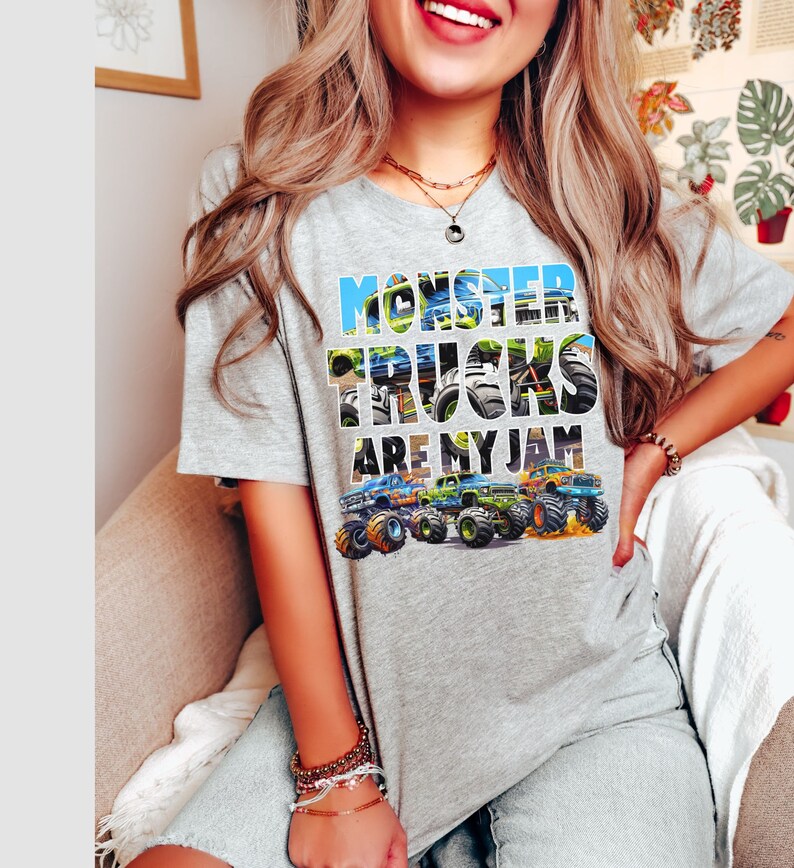 May include: Gray t-shirt with a graphic of monster trucks and the text "Monster Trucks Are My Jam".