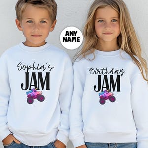 May include: White sweatshirts with black text that reads "Sophia's JAM" and "Birthday JAM". Each sweatshirt features a colorful monster truck graphic. The sweatshirts are designed for children and are suitable for birthday celebrations.