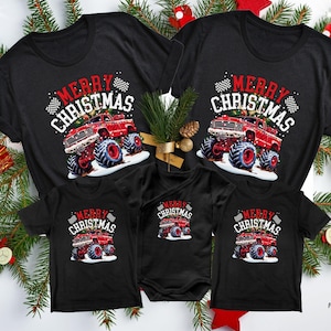 Pictured are 5 T-Shirts that match in design. they are all black and all say "MERRY CHRISTMAS" in red and white bold font. There is a big red monster truck in holiday snow and 2 checkered flags