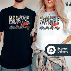 May include: Two t-shirts, one black and one white, with a monster truck theme. The black shirt says "Dadster Jam" and the white shirt says "Momster Jam". Both shirts feature a line of monster trucks with colorful designs.