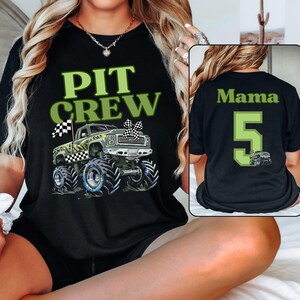Pictured is a Mother wearing a Pit Crew Black Tee with a camo green monster truck graphic with a checkered flag. On the back is custom name Mama and a big number 5 in college varsity font