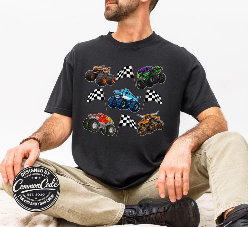a man wearing a comfort colors tee with checkered racing flags and various monster truck jam vehicles trucks. shark truck, digger truck, megalodon, dragon, tiger shark, bull toro truck. Perfect for Matching dad & son outfits, Birthday parties (truck theme), Race Day truck or car show events, Father's day gifts, everyday casual wear for the truck loving dad and boy and girl. available in adult, youth, toddler and infant baby sizes.