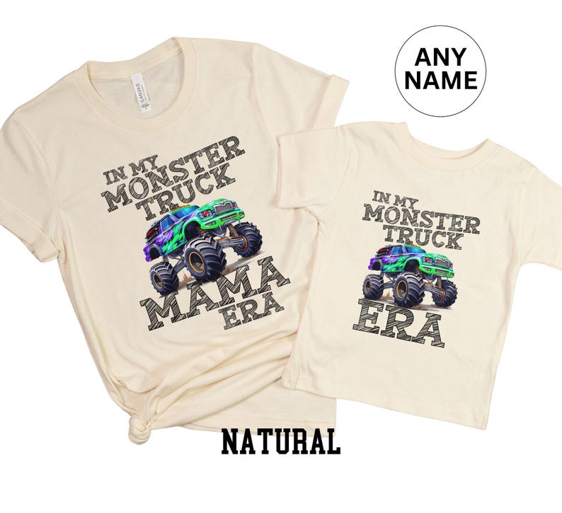 May include: Two cream-coloured t-shirts. One adult-sized shirt with the text "IN MY MONSTER TRUCK MAMA ERA" and a graphic of a monster truck. The other is a child-sized shirt with the text "IN MY MONSTER TRUCK ERA" and a monster truck graphic.