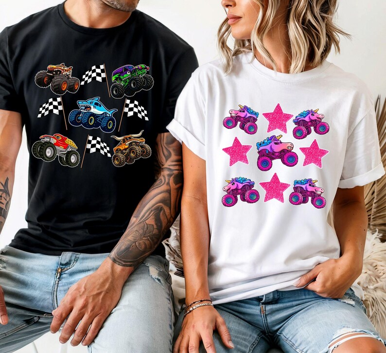 May include: Black t-shirt with colorful monster truck graphics and checkered flags. White t-shirt with pink star and unicorn monster truck graphics. Both shirts are short-sleeved and suitable for casual wear.