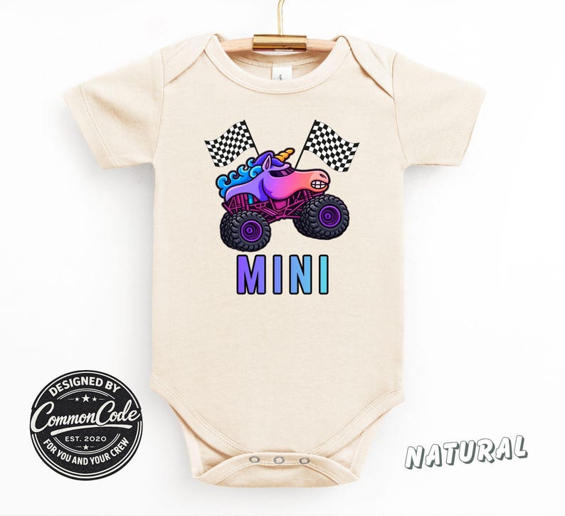 May include: A beige baby bodysuit with a colorful graphic of a unicorn monster truck and the word "MINI". The design includes checkered flags and the text "DESIGNED BY Common Code EST. 2020 FOR YOU AND YOUR CREW".