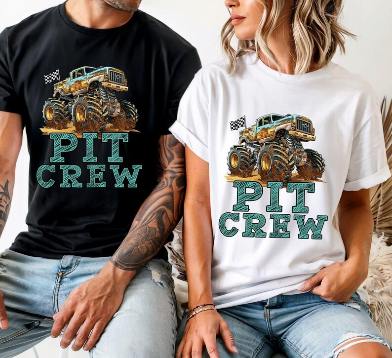 May include: Black and white t-shirt featuring a monster truck graphic with a checkered flag and the words "PIT CREW" in teal. The monster truck is beige, blue, and brown.