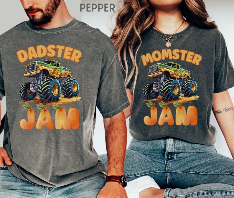 May include: A matching set of two gray t-shirts with a monster truck graphic and the text "DADSTER JAM" and "MOMSTER JAM". The monster truck is green, yellow, and black with orange wheels. The text is in orange.