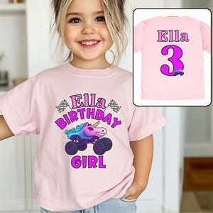 Pictured is a young girl wearing a pink t-shirt which says Ella BIRTHDAY GIRL in pink and purple font, a large graphic of a unicorn monster truck in sparkle smash design theme with checkered flags. On the back of this 2-sided design is custom name Ella, a big number 3 (also a custom number) and a small version of the truck
