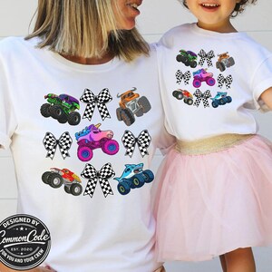 May include: White t-shirts with colorful monster truck graphics and checkered bows. The shirts feature various monster truck designs in green, purple, orange, pink, red, and blue. The bottom of the shirt has a circular logo that says "DESIGNED BY COMMON CODE EST. 2020 FOR YOU AND YOUR CREW."