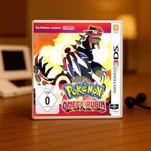 Può includere: Custodia del gioco per Nintendo 3DS per "Pokémon Omega Rubino". La copertina presenta una creatura rossa e nera con accenti bianchi su uno sfondo infuocato. Il titolo del gioco è in un font stilizzato con colori blu e giallo. La custodia ha i loghi Nintendo e The Pokémon Company.