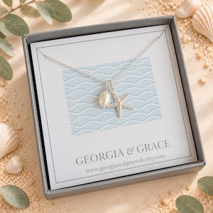 May include: A silver chain necklace featuring a small white oval pearl charm and a textured silver starfish pendant, presented on a white card with blue wave patterns and the text GEORGIA & GRACE and www.georgiaandgraceuk.etsy.com in a box.
