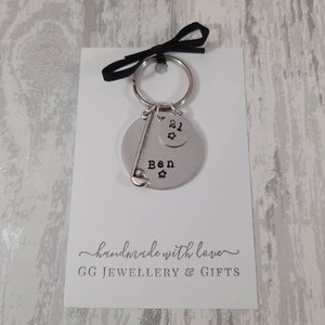 May include: A silver keychain with a golf club charm and a round tag that says "Ben" with a star. A smaller round tag with the number "21" and a star is attached to the keychain. The keychain is on a white card with the text "handmade with love" and "GG JEWELLERY & GIFTS".