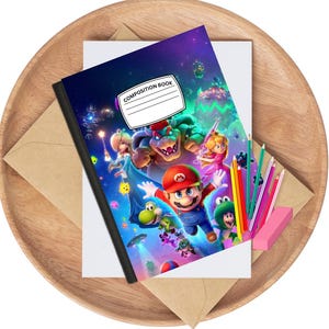 May include: A composition book featuring a colorful graphic of Mario, Bowser, Princess Peach, Rosalina, and Yoshi against a space background. The cover includes a white label with the text COMPOSITION BOOK. Several colored pencils and a pink eraser.