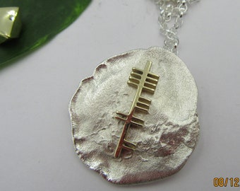 LOVE in gold In Ogham on silver background .