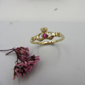 14k yellow gold CLADDAGH RING with ruby.