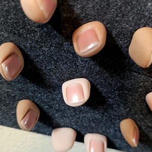 Realistic human thumb tack
