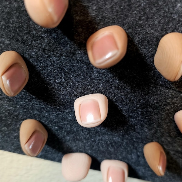 Realistic human thumb tack