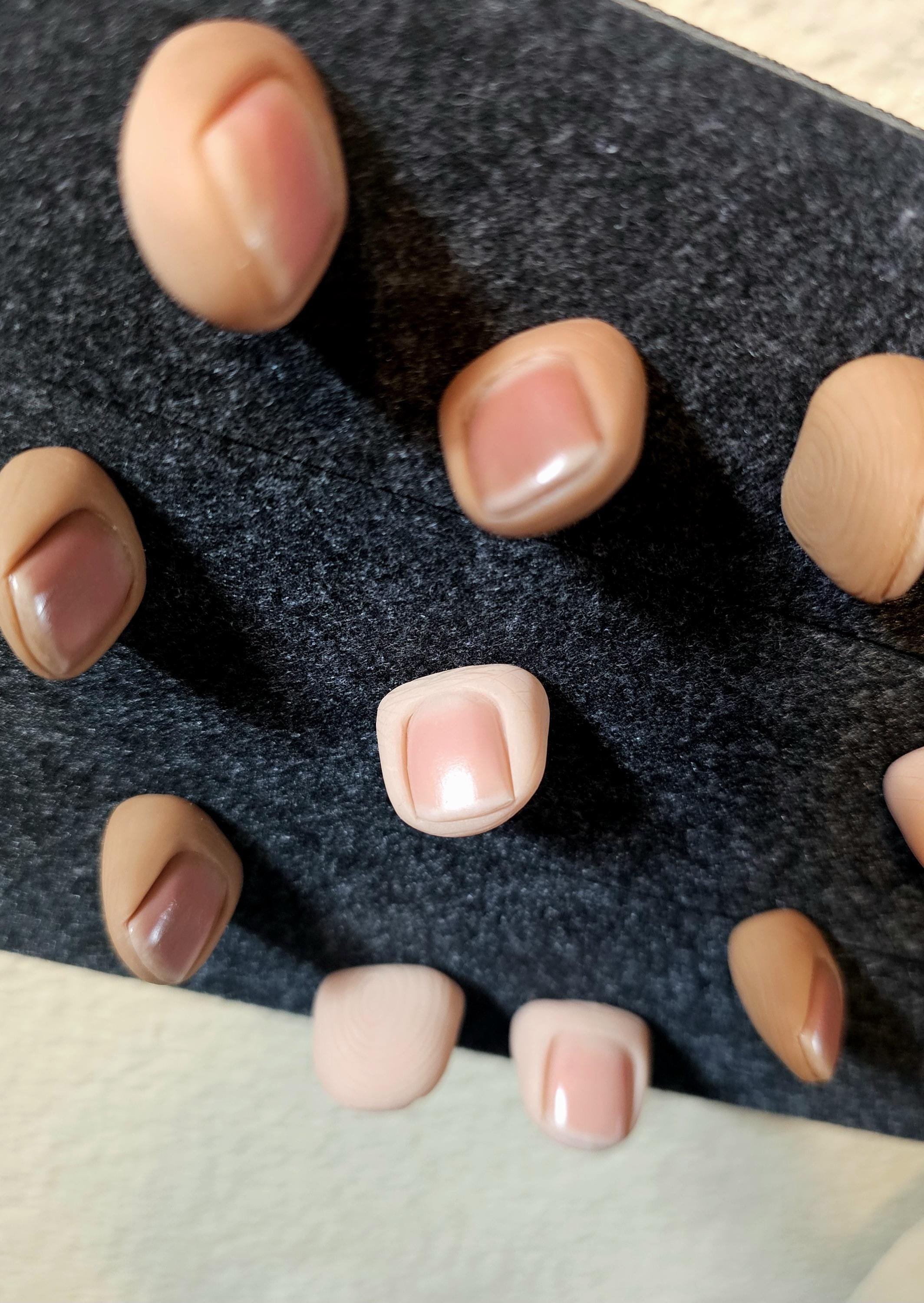Realistic human thumb tack