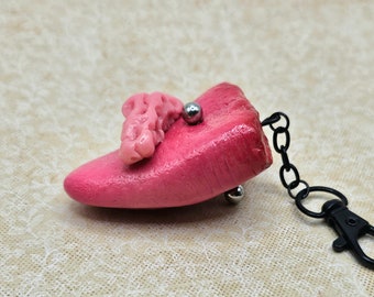 Pierced tongue charm with gum