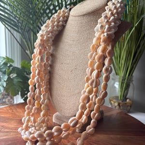 May include: A set of three ceramic mugs with a speckled, matte finish. The mugs are in shades of cream, light gray, and dark gray. Each mug has a simple, minimalist design and a rounded handle. Perfect for coffee or tea.