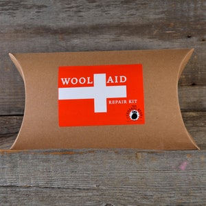 May include: A brown paper envelope with a red and white sticker that says "Wool Aid Repair Kit" and a logo for "The General Bean".