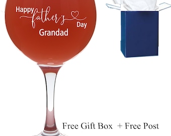 May include: A clear glass with a stem and a round bowl. The glass is filled with a red liquid. The glass has the text "Happy father's Day Grandad" etched on the side.