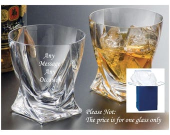 May include: Two clear glass tumblers with a twisted base design. One glass is empty and engraved with the text Any Message Any Occasion, while the other is filled with amber liquid and ice cubes. A blue gift box is shown in the corner.