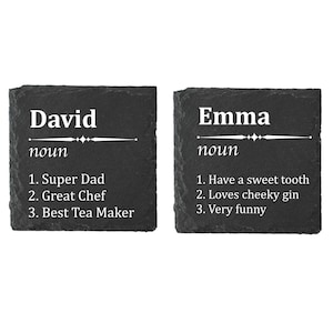 May include: Two black slate coasters with white text. The first coaster says "David noun 1. Super Dad 2. Great Chef 3. Best Tea Maker". The second coaster says "Emma noun 1. Have a sweet tooth 2. Loves cheeky gin 3. Very funny".