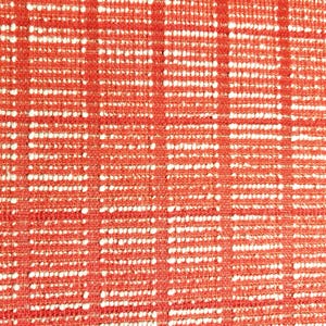 May include: Red fabric with a white woven pattern. The fabric has a textured surface.