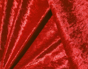 May include: Close-up of a red velvet fabric with a soft, plush texture. The fabric is folded and draped, creating a luxurious and elegant look.