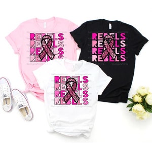 May include: Three t-shirts in pink, black, and white with a pink ribbon with a leopard print design and the word "REBEL" repeated in pink shades.