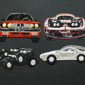 May include: Four beaded car patches. The top left patch is a red BMW with the brand name spelled out. The top right patch is a black and red Corvette. The bottom left patch is a black vintage car. The bottom right patch is a silver car.